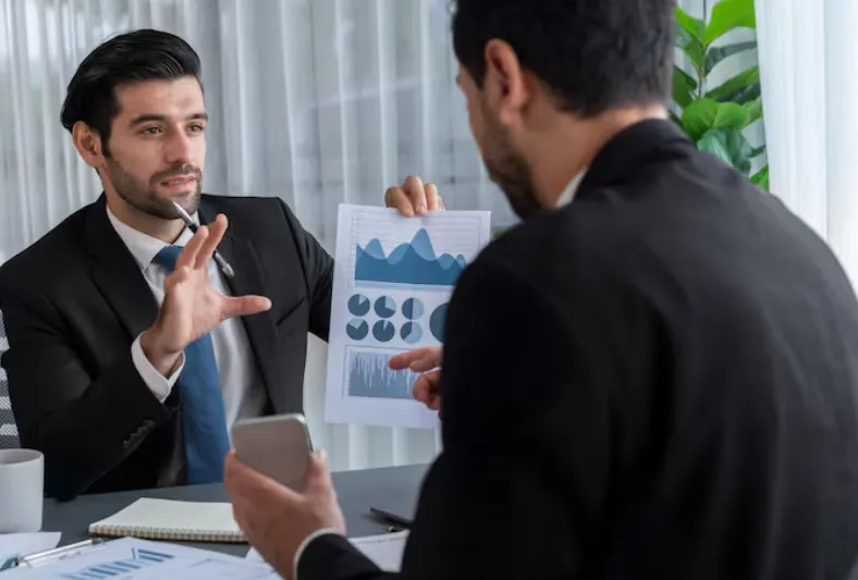 Business professional analyzing customer retention metrics and growth charts on laptop to prevent revenue decline