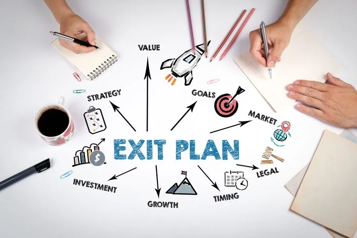 Business owner contemplating strategic exit planning options while reviewing documents at desk